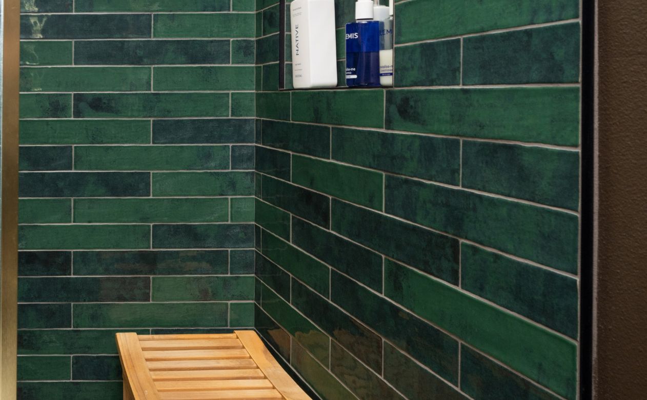 green shower tile installation and grey waterproof shower tile floor in Santee, CA with wood bench and window