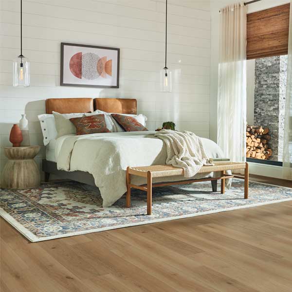 hardwood flooring in bedroom with area rug