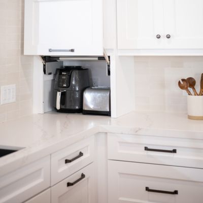 kitchen countertop corner with appliances and white cabinets