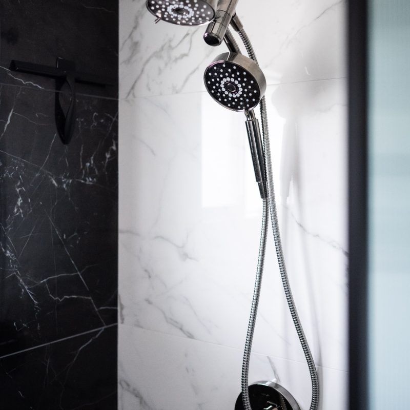 custom black and white shower tile with silver hardware